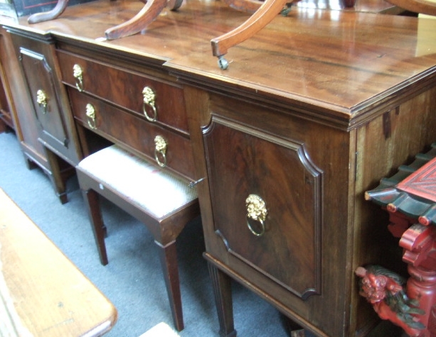 Appraisal: A mahogany and walnut inverted breakfront sideboard with a pair