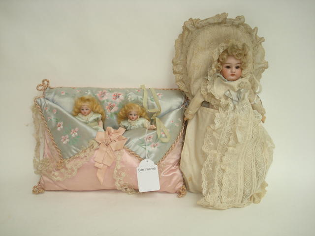 Appraisal: Miniature twin Simon Halbig bisque head sewing dolls in pillow