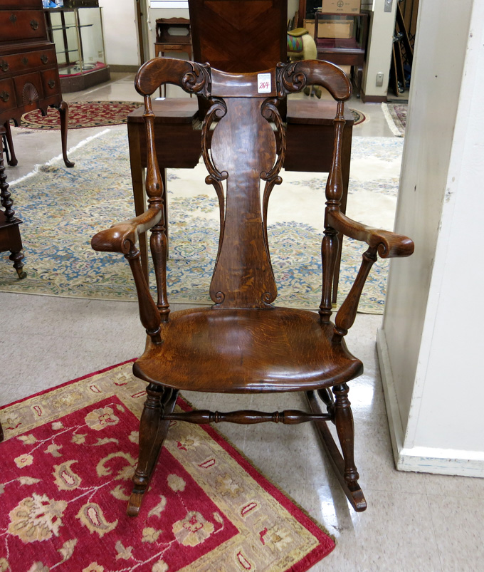 Appraisal: CARVED OAK ROCKING ARMCHAIR American c having a carved vertical