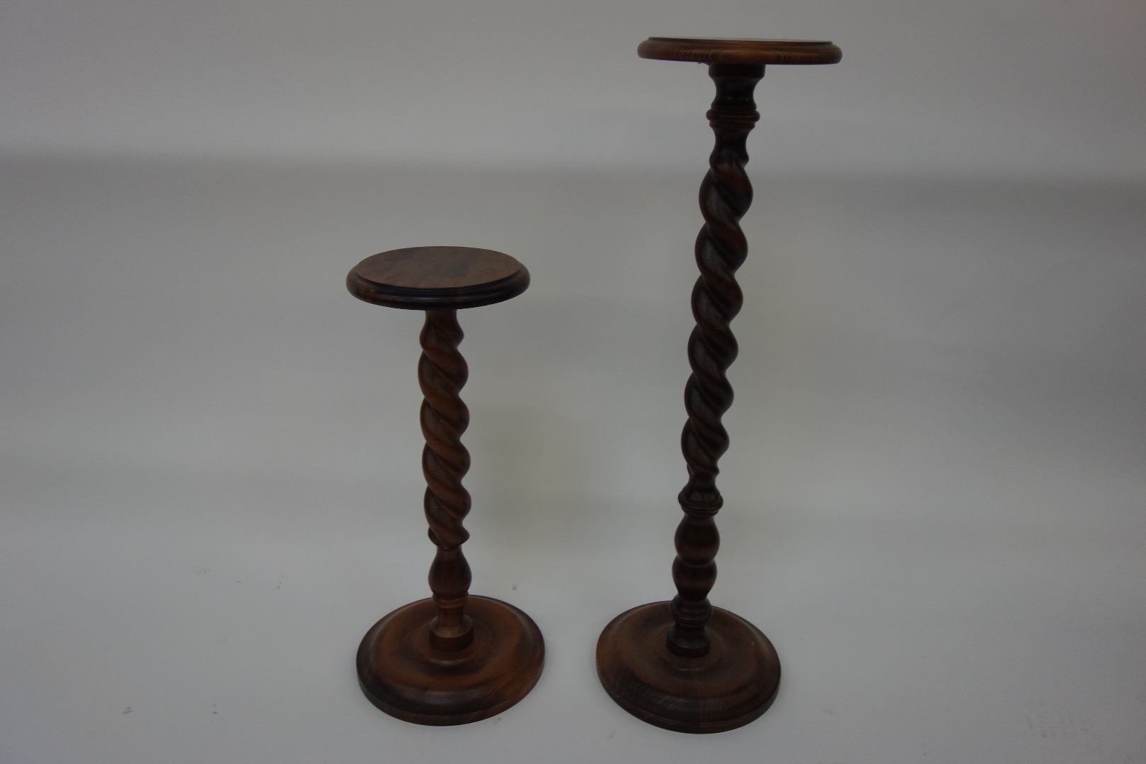 Appraisal: A graduated pair of modern wooden spiral column plant stands