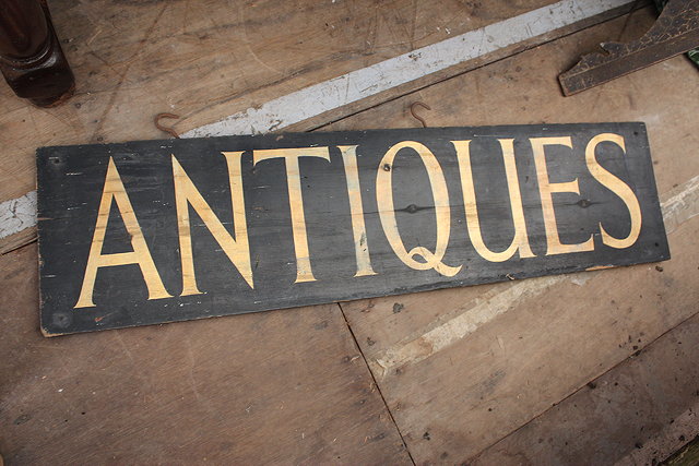 Appraisal: AN EARLY TH CENTURY RECTANGULAR PAINTED PINE 'ANTIQUES SHOP' SIGN