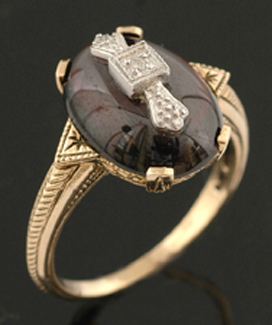 Appraisal: A garnet and diamond dress ring The oval garnet cut