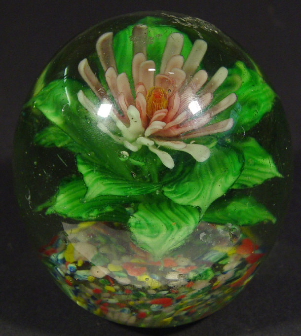 Appraisal: Large glass dump weight with floral inclusion cm high