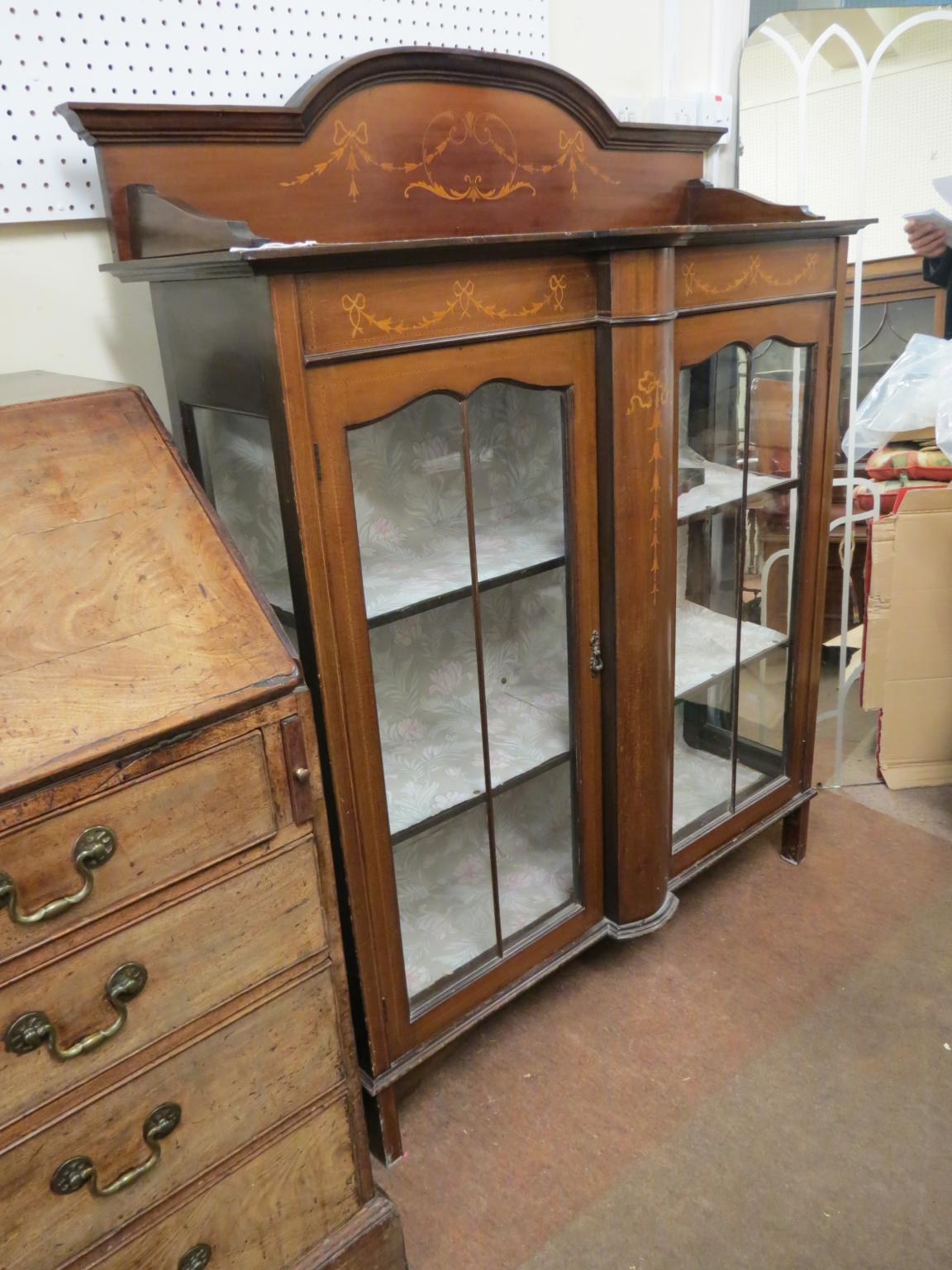 Appraisal: An Edwardian inlaid mahogany display cabinet pair of astragal-glazed doors