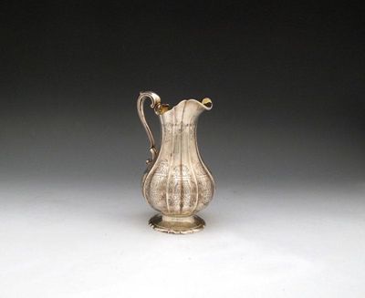 Appraisal: A Victorian silver cream jug by W Williams London lobed