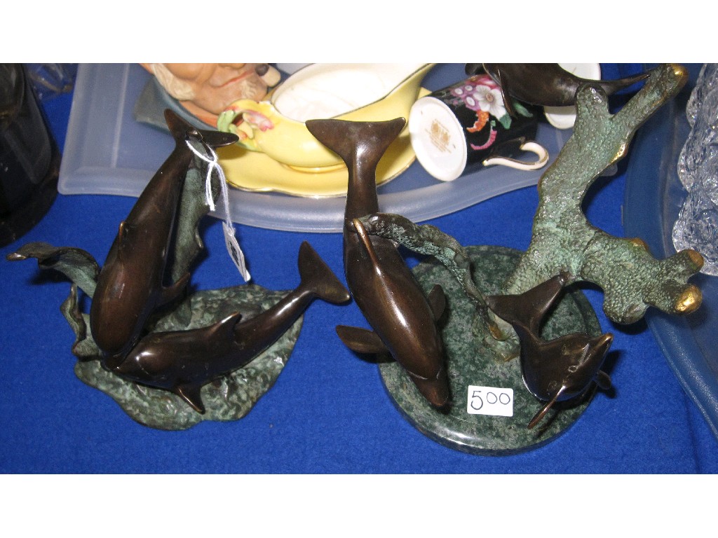 Appraisal: Lot comprising two cast metal and bronze figures of dolphins