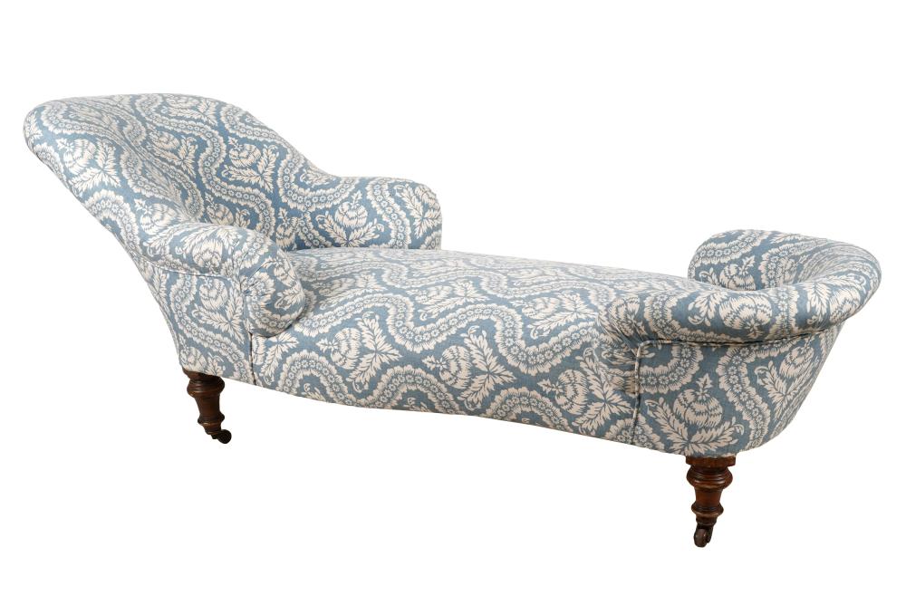 Appraisal: UPHOLSTERED CHAISE LOUNGEthe turned legs raised on casters Dimensions x