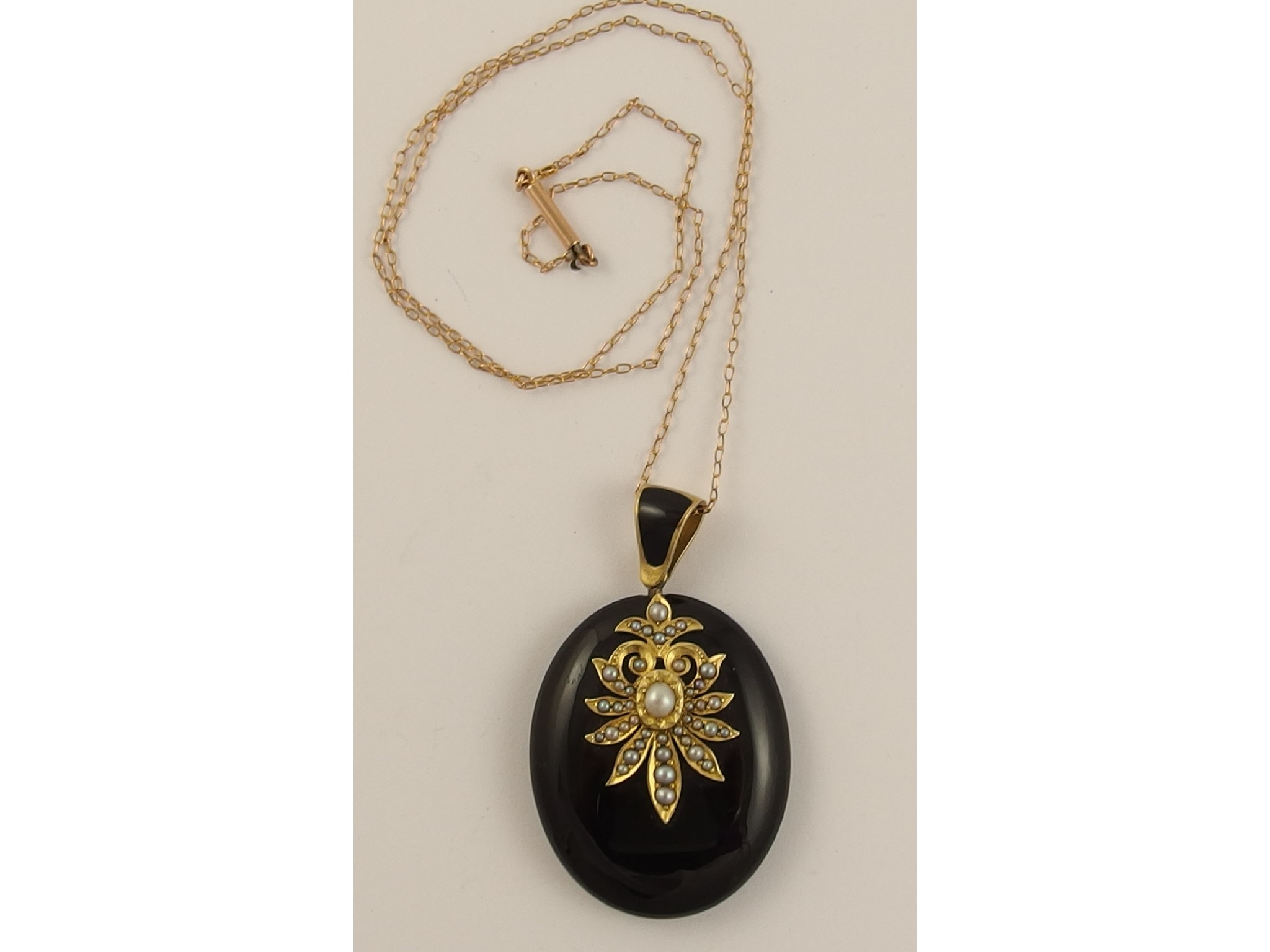 Appraisal: A Victorian mourning pendantin onyx black enamel and yellow metal