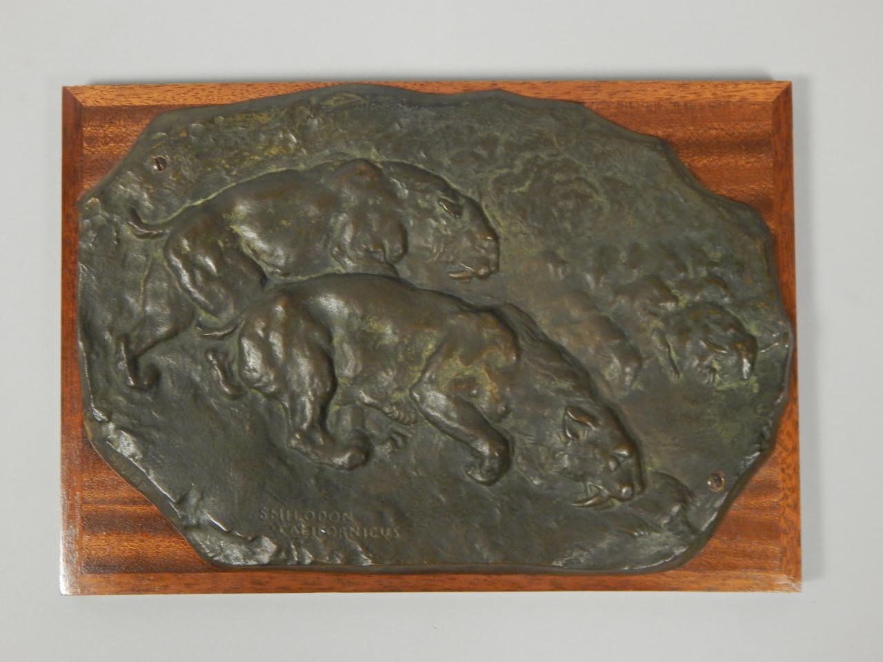 Appraisal: Huff Smilodon Californicus bronze plaque depicting sabre tooth tigers on