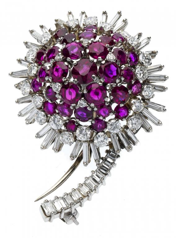 Appraisal: A RUBY AND DIAMOND FLOWER BROOCH with domed centre the