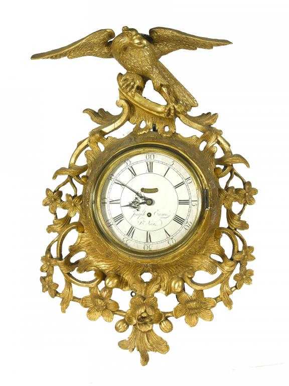 Appraisal: A GEORGE III GILTWOOD CARTEL TIMEPIECE the circular silvered dial