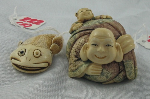 Appraisal: TWO ASIAN IVORY HAND CARVED NETSUKE the first a large