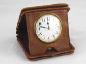 Appraisal: A travelling clock in fold down leather case Swiss made