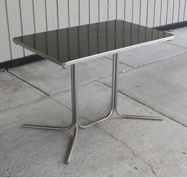 Appraisal: Machine age tubular chrome dining table with black bakelite top