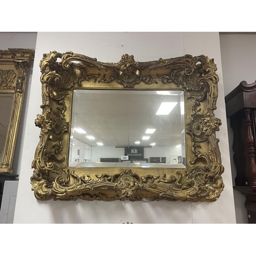 Appraisal: Antique elaborate rectangular wall mirror with a bevelled plate within