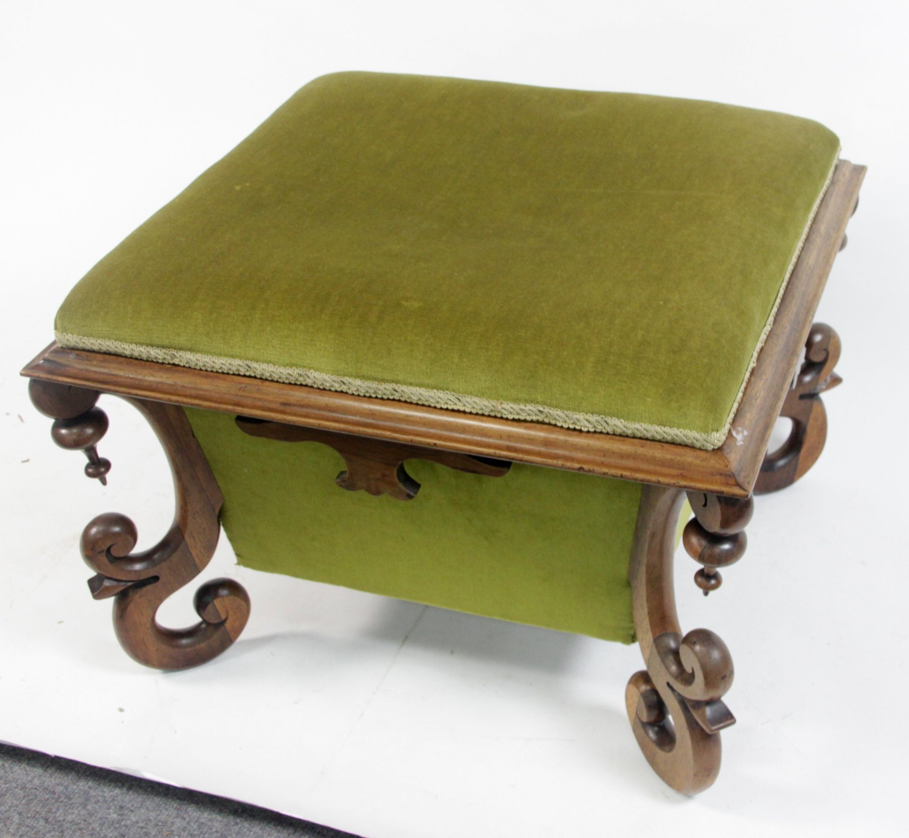 Appraisal: A Victorian walnut box ottoman with padded hinged top on