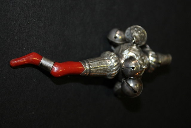 Appraisal: A VICTORIAN WHITE METAL BABY'S RATTLE incorporating a whistle and