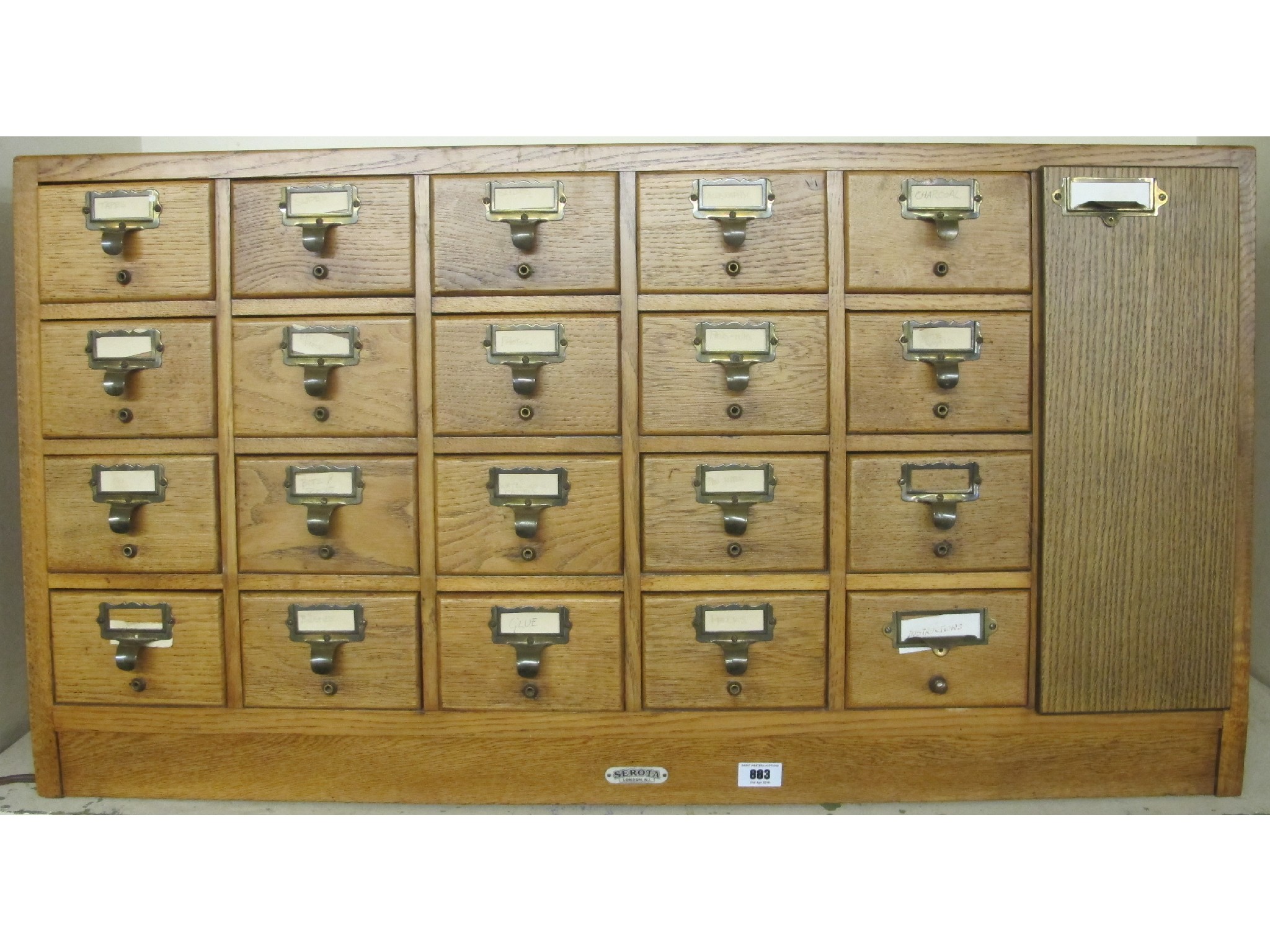 Appraisal: A sloping twenty drawer and cupboard oak filing cabinet by