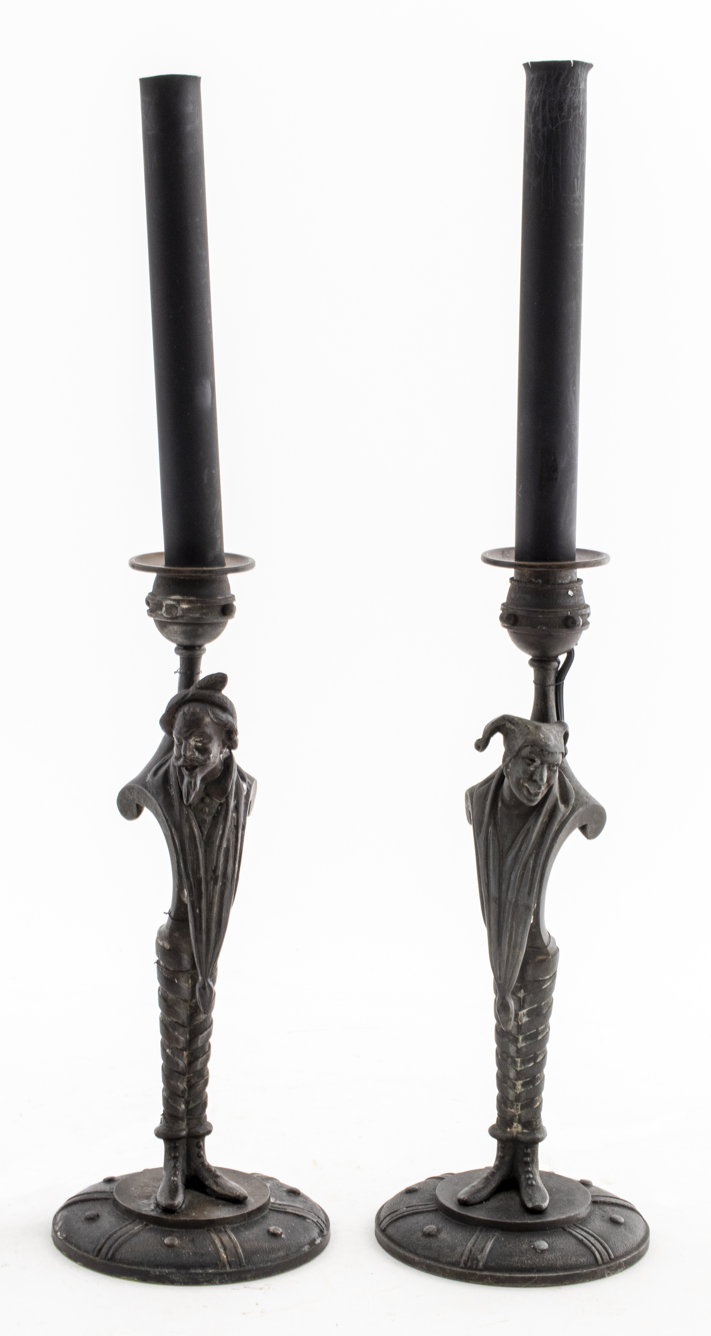 Appraisal: ALLEGORICAL FIGURE METAL CANDLESTICKS Two metal candlesticks the standards modeled