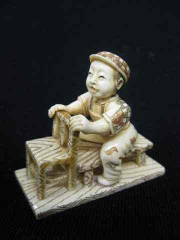 Appraisal: Carved Ivory Netsuke of a Seated Boy fancy polychrome signed