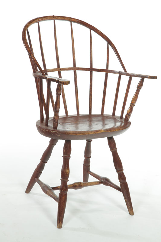 Appraisal: SACK-BACK WINDSOR ARMCHAIR American late th century mixed woods Baluster-turned