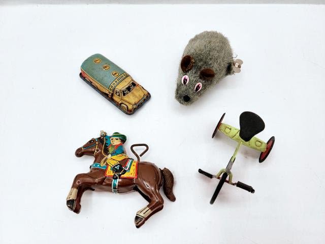 Appraisal: A group of small tin toys Includes a Cowboy on