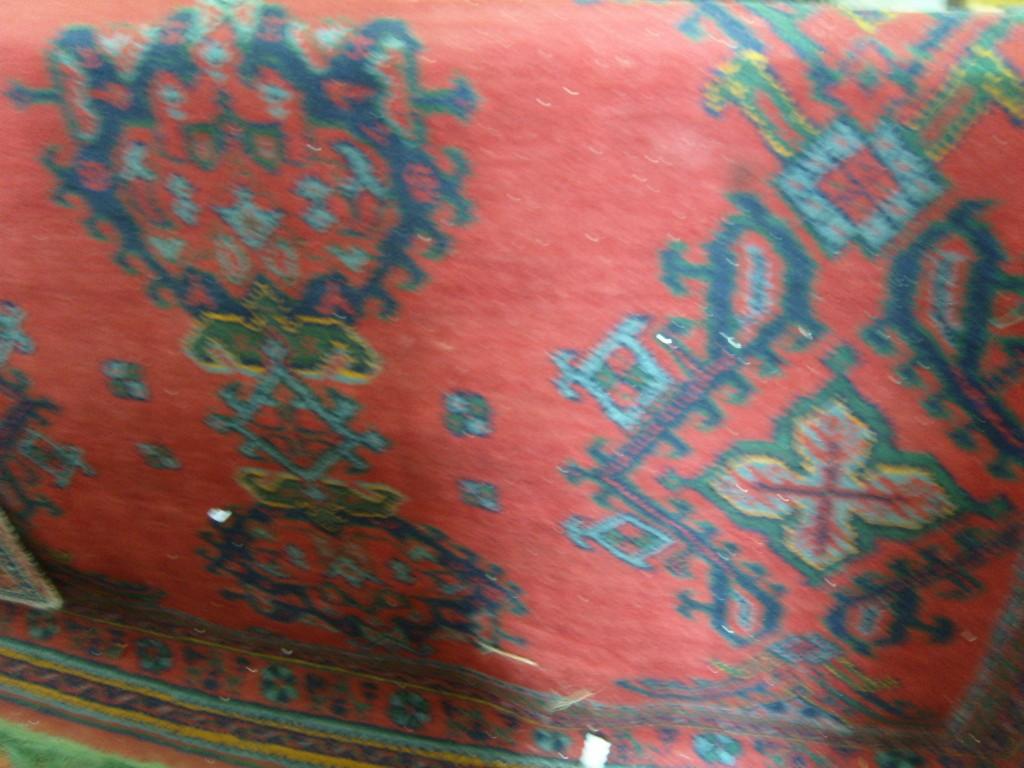 Appraisal: A red ground Turkey type wool carpet with green blue