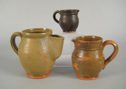 Appraisal: Three redware pitchers inscribed Thomas Stahl all with mottled green