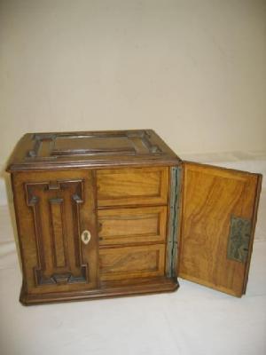 Appraisal: A BURR WALNUT TRINKET CABINET of canted oblong form with