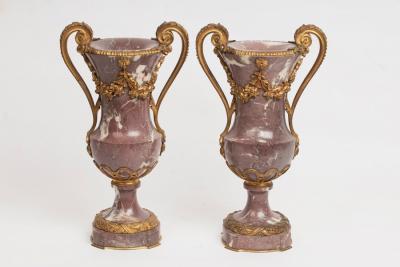 Appraisal: A pair of mauve veined marble vases of Classical form