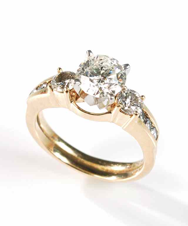 Appraisal: DIAMOND AND FOURTEEN KARAT GOLD RING featuring a round brilliant-cut