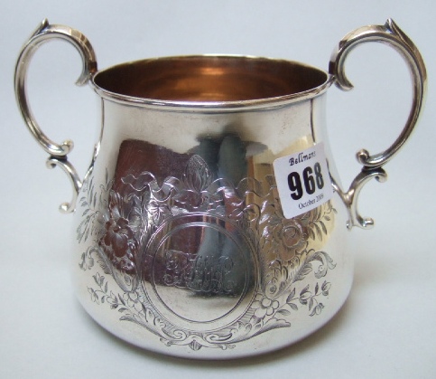 Appraisal: A Victorian silver twin handled sugar bowl with floral foliate