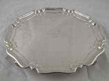 Appraisal: A silver salver with scroll feet and shaped rim Sheffield