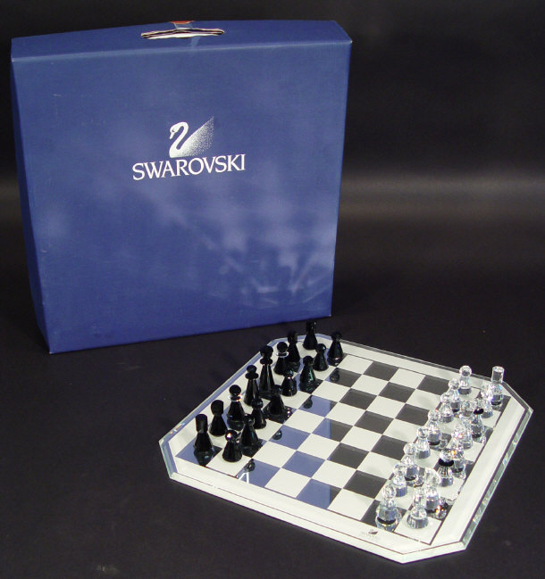 Appraisal: Boxed Swarovski set of crystal chess pieces half with black