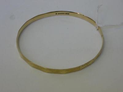 Appraisal: A CT GOLD SLAVE BANGLE of faceted form with navette