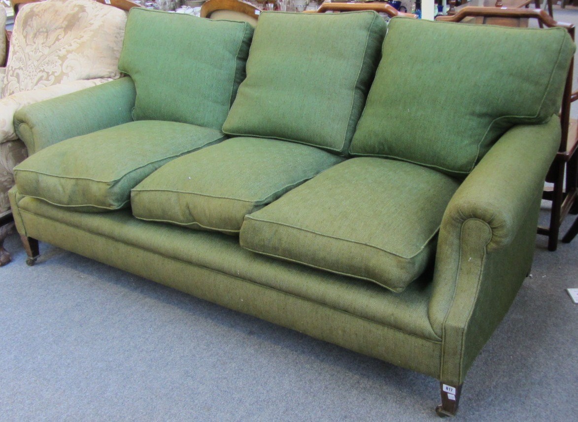 Appraisal: In the manner of Howard a deep three seat sofa