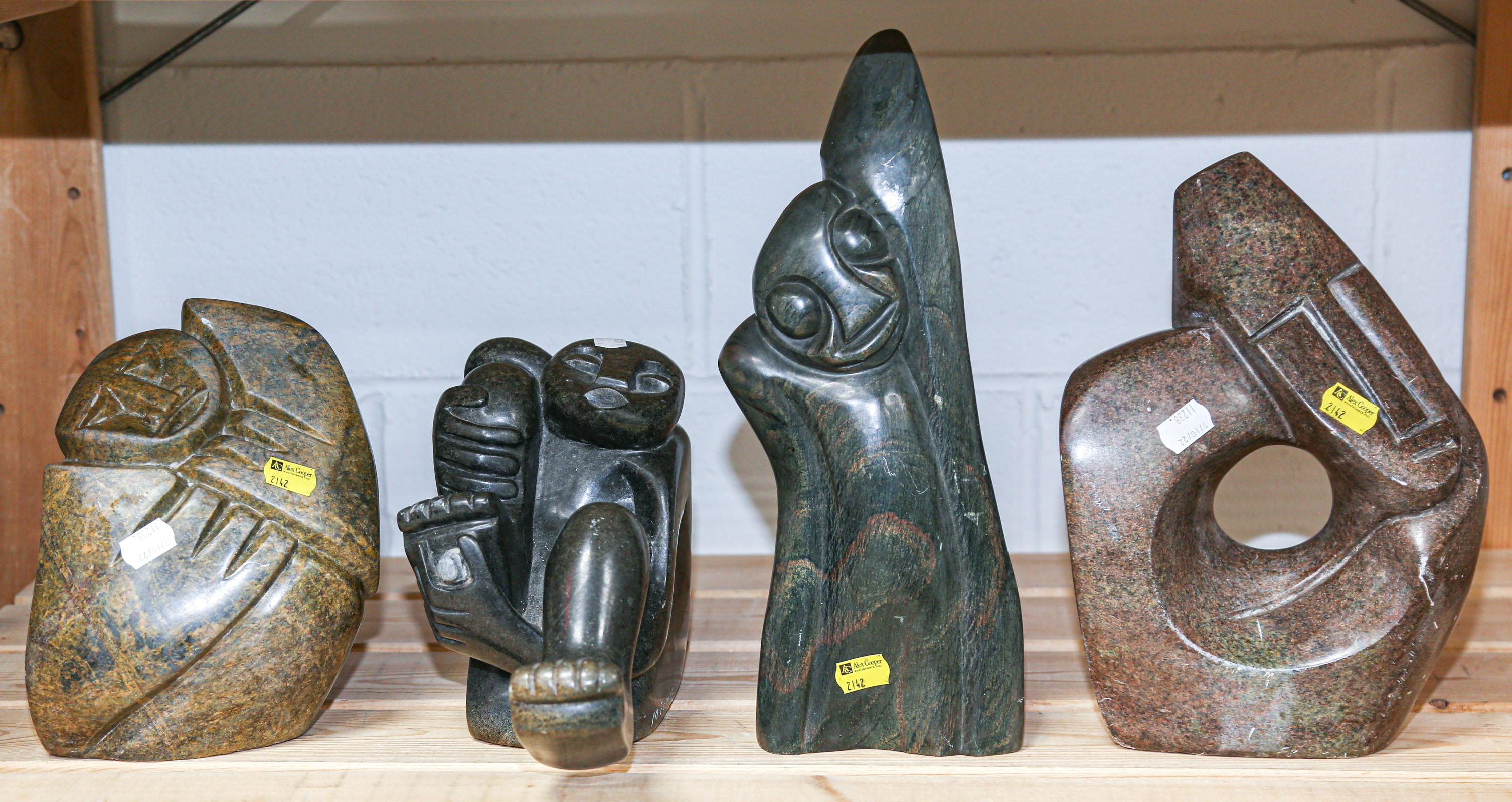 Appraisal: FOUR ABSTRACT SHONA SOAPSTONE SCULPTURES to in H