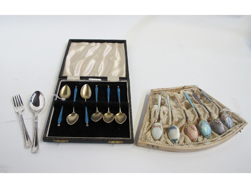 Appraisal: Lot comprising two cased sets of silver and enamel spoons