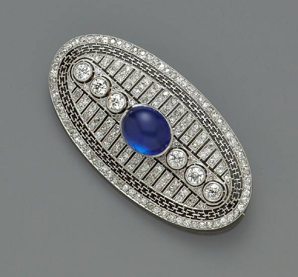 Appraisal: A sapphire and diamond brooch centering one oval cabochon sapphire