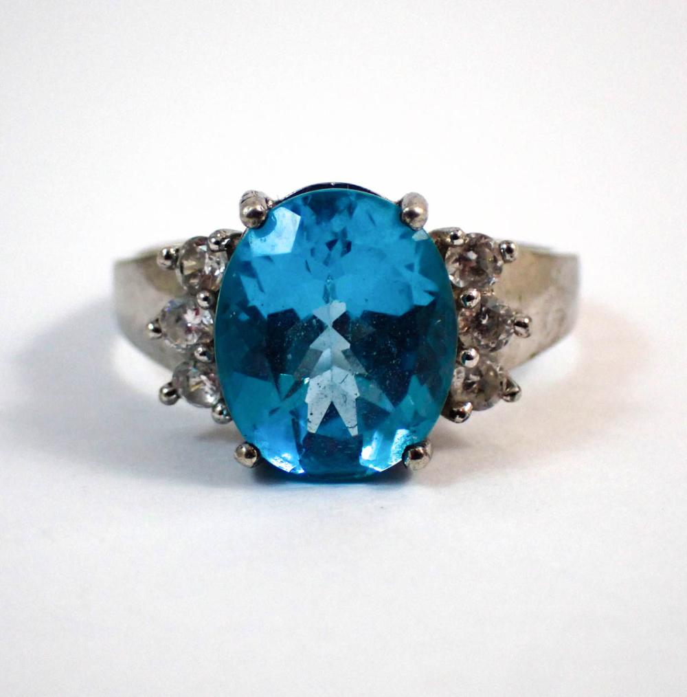 Appraisal: BLUE TOPAZ AND FOURTEEN KARAT WHITE GOLD RING with three