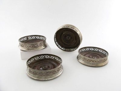 Appraisal: A set of four George III silver wine coasters of