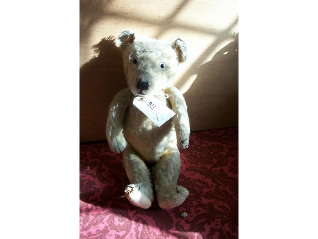 Appraisal: An old straw filled teddy bear with yellow plush coat