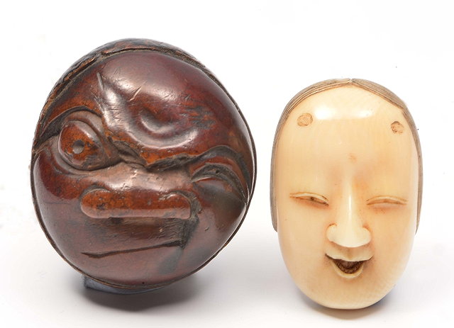 Appraisal: A JAPANESE IVORY MASK NETSUKE carved as a female mask