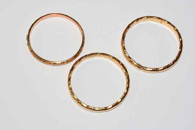 Appraisal: A PAIR OF HINGED BANGLES in the form of bamboo