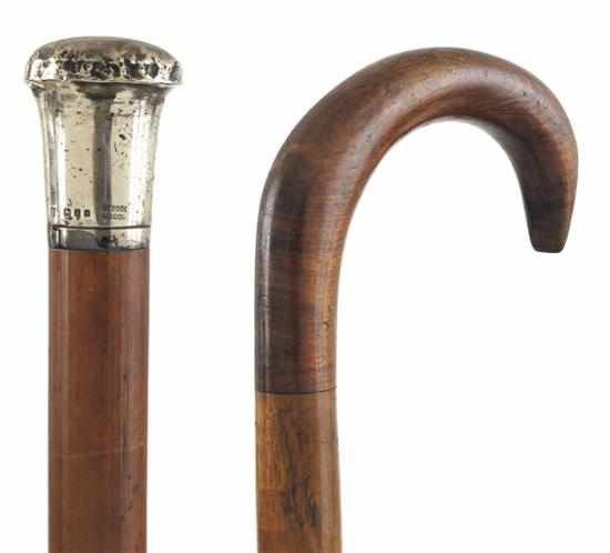 Appraisal: TWO WOODEN WALKING STICKS One with a sterling silver mount