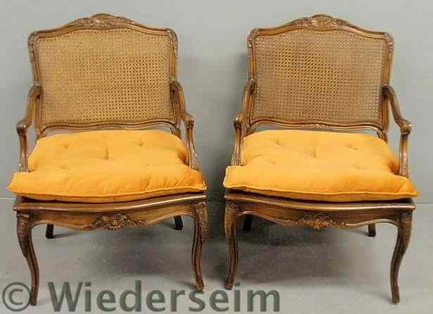 Appraisal: Pair of Italian fruitwood open armchairs with cane backs h