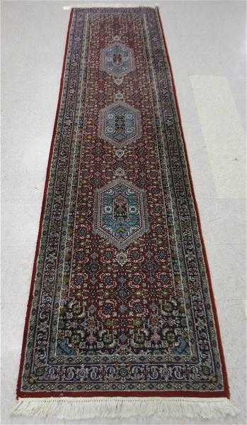 Appraisal: HAND KNOTTED ORIENTAL RUNNER Indo-Bijar three geometric medallions and Herati