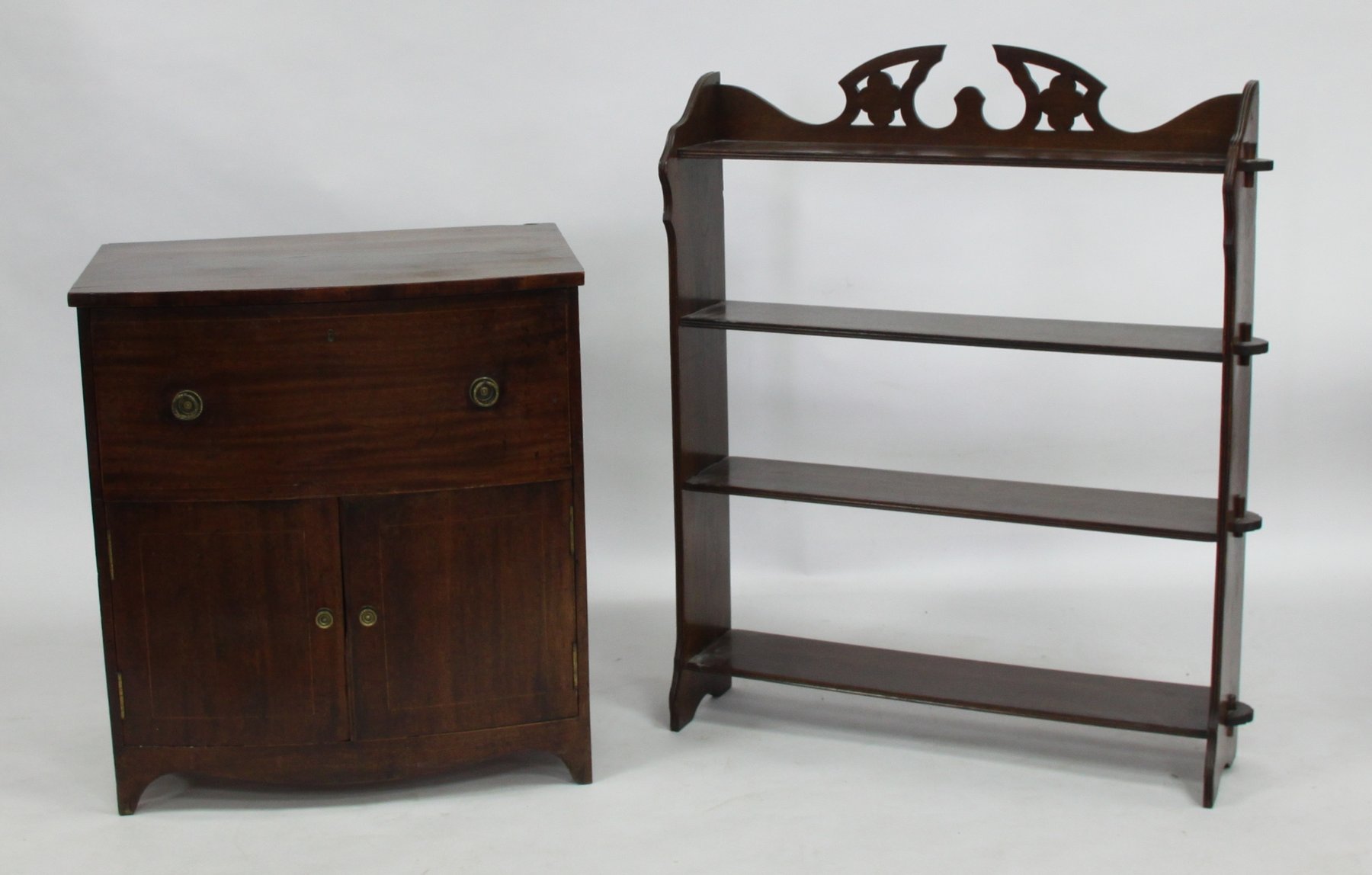 Appraisal: A mahogany bowfront cabinet fitted a drawer above a cupboard