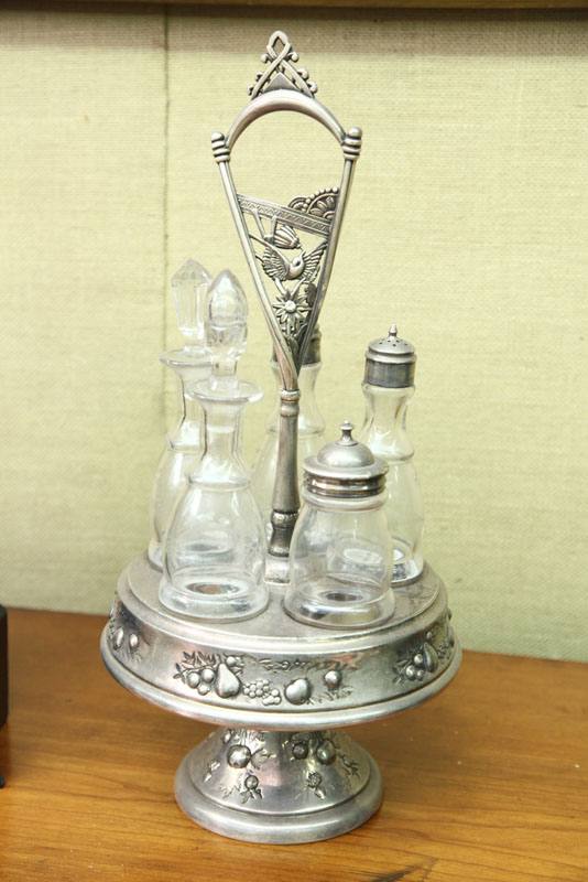 Appraisal: CRUET SET Silver plate holder with fruit decoration and twisted