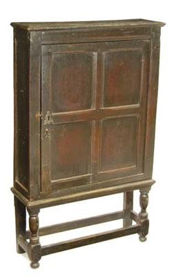 Appraisal: A panelled oak cupboard on a later stand the cupboard